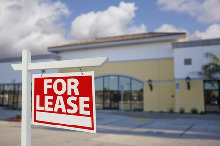 Vacant Retail Building with For Lease Real Estate Sign in Front.の写真素材