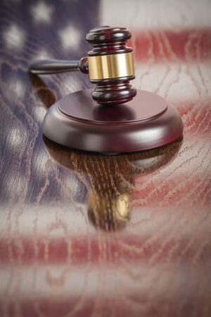 Wooden Gavel Resting on American Flag Reflecting Table.の写真素材