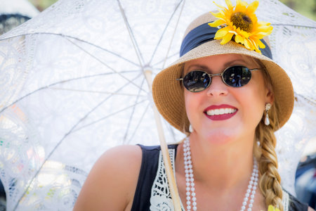 Young Attractive Woman in Twenties Outfit Holding Parasol.