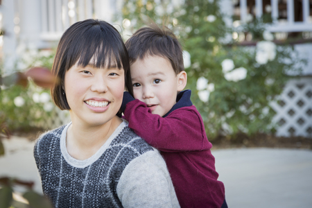 Happy Chinese Mother Having Fun with Her Mixed Race Baby Son.の写真素材