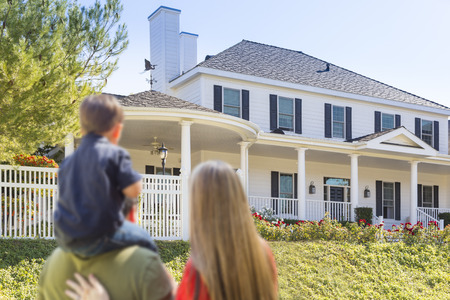 Mixed Race Young Family Looking At Beautiful New Home.の写真素材
