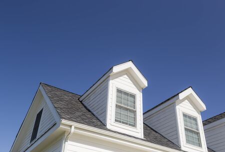Roof of House and Windows Against Beautiful Deep Blue Sky.の写真素材