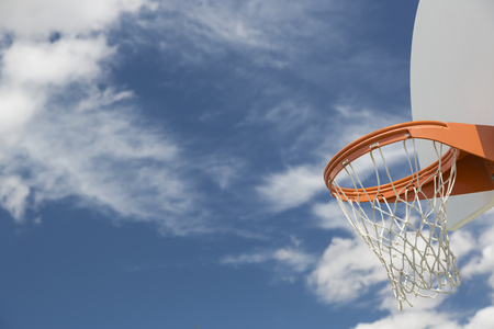 Abstract of Community Basketball Hoop and Net Against Blue Sky.の写真素材