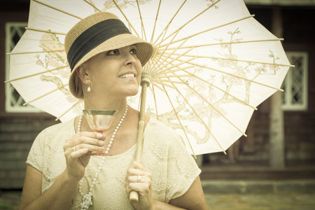 Beautiful 1920s Dressed Girl with Parasol and Glass of Wine Portrait.