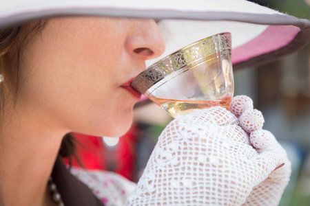 Pretty 1920s Dressed Girl with Hat, Gloves and Glass of Wine.