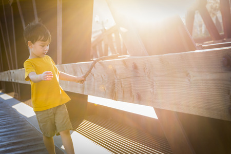Handsome Mixed Race Boy Walking on Bridge Outdoors.の写真素材