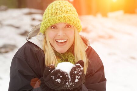 Attractive Woman Having Fun in the Snow on a Winter Day.の写真素材