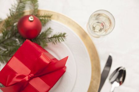 Beautiful Christmas Gift with Place Setting Abstract at Table.の写真素材