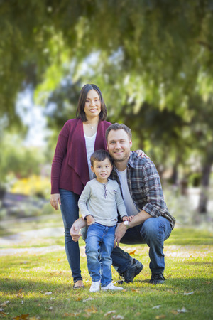 Happy Attractive Mixed Race Young Family Portrait Outdoors.の写真素材
