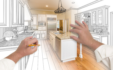 Male Hands Sketching with Pencil A Custom Kitchen with Photo Showing Through.の写真素材