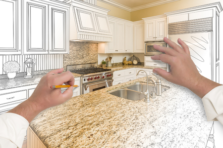 Male Hands Sketching with Pencil A Custom Kitchen with Photo Showing Through.の写真素材