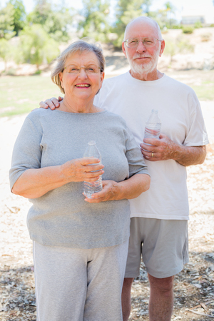Happy Healthy Senior Couple with Water Bottles Outdoors.の写真素材