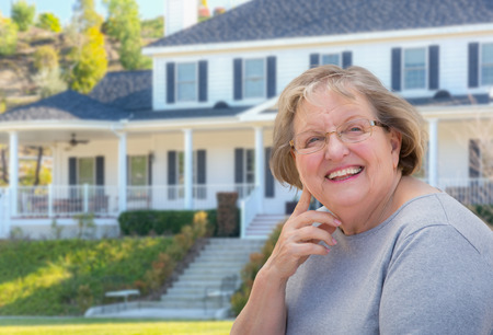 Senior Adult Woman in Front of Beautiful House.の写真素材
