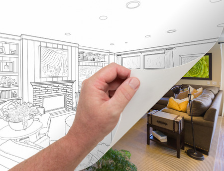 Male Hand Turning Page of Custom Living Room Photograph to Drawing Underneath.の写真素材
