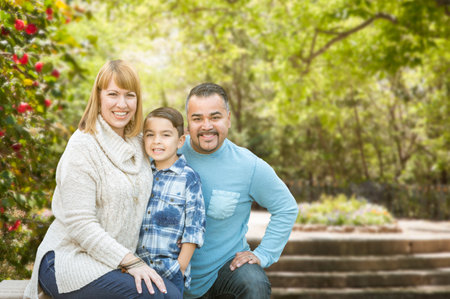Happy Mixed Race Hispanic and Caucasian Family Portrait at the Park.