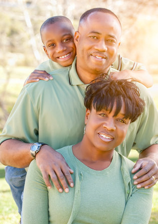 Beautiful Happy African American Family Portrait Outdoors At The Park.