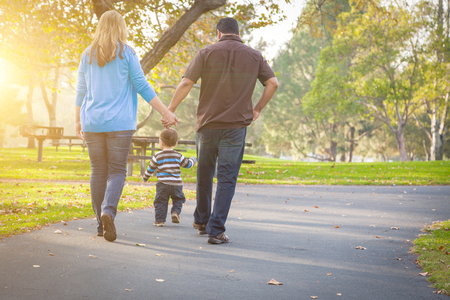 Happy Young Mixed Race Ethnic Family Walking In The Park.の写真素材