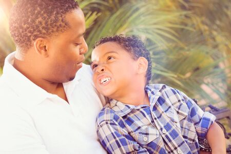 Mixed Race Son and African American Father Playing Outdoors Together.の写真素材