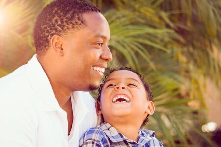 Mixed Race Son and African American Father Playing Outdoors Together.の写真素材