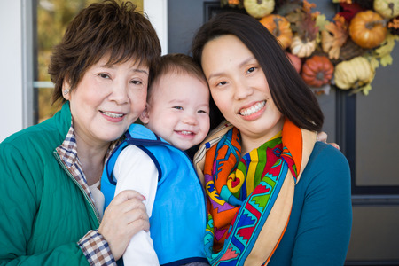 Happy Chinese Senior Adult Grandmother with Her Daughter and Grandsonの写真素材