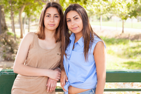 Two Beautiful Ethnic Twin Sisters Portrait Outdoors.の写真素材