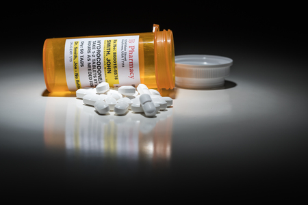 Hydrocodone Pills and Prescription Bottle with Non Proprietary Label. No model release required - contains ficticious information.の写真素材