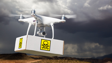 Unmanned Aircraft System (UAV) Quadcopter Drone Carrying Package With Poison Symbol Label Near Stormy Skies.の写真素材