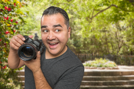 Hispanic Young Male Photographer With DSLR Camera Outdoorsの写真素材