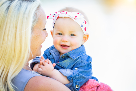 Young Caucasian Mother and Daughter At The Park.の写真素材