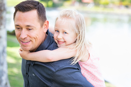 Young Caucasian Father and Daughter Having Fun At The Park.の写真素材