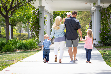 Young Caucasian Family Taking A Walk In The Park.の写真素材