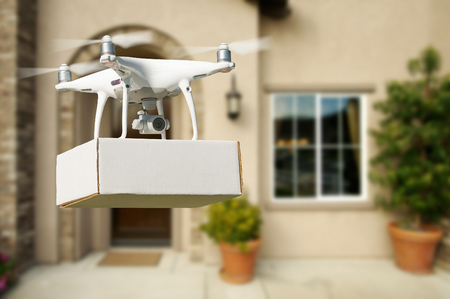 Unmanned Aircraft System (UAV) Quadcopter Drone Delivering Package At House.の写真素材