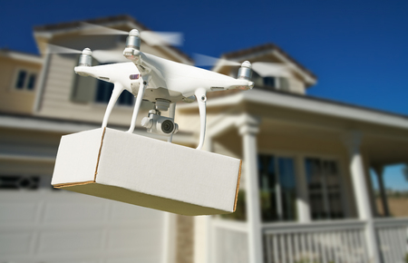 Unmanned Aircraft System (UAV) Quadcopter Drone Delivering Package At House.の写真素材