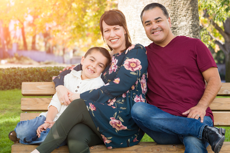 Mixed Race Young Family Portrait At The Park.の写真素材
