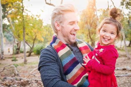 Handsome Caucasian Young Man with Mixed Race Baby Girl Outdoors.の写真素材