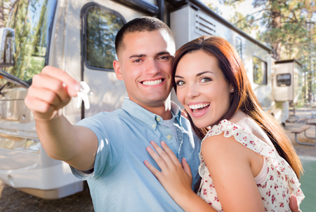 Young Military Couple Holding Keys In Front of New RV.の写真素材