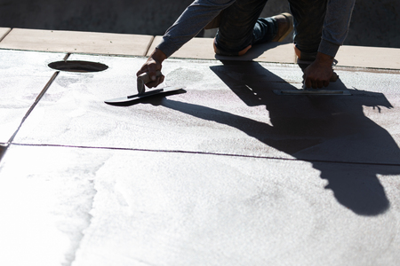 Construction Worker Smoothing Wet Cement With Trowel Toolsの写真素材
