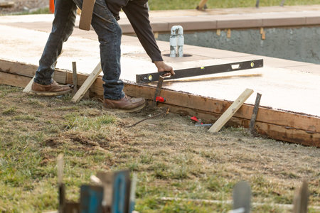 level, pooring; construction; construction site; cement; pool; deck; wet; fresh; worker; working;...
