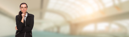 Serious Mixed Race Businesswoman Inside Building Banner.の写真素材