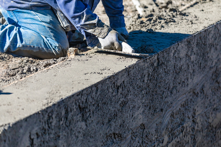 Pool Construction Worker Working With Wood Float On Wet Concreteの写真素材