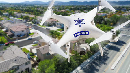 Police Unmanned Aircraft System, (UAS) Drone Flying Above A Neighborhood and Street.