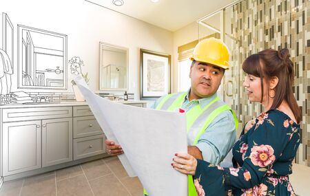 Hispanic Male Contractor Talking with Female Client Over Blueprint Plans In Front of Bathroom Drawing Gradating to Photo.の写真素材