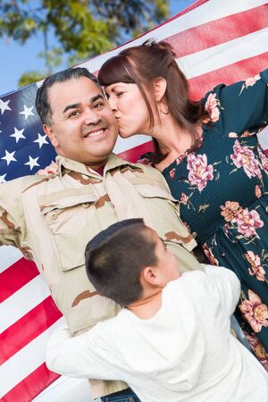 Male Hispanic Armed Forces Soldier Celebrating His Return Holding American Flag.の写真素材
