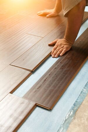 Man Installing New Laminate Wood Flooring Abstract.の写真素材