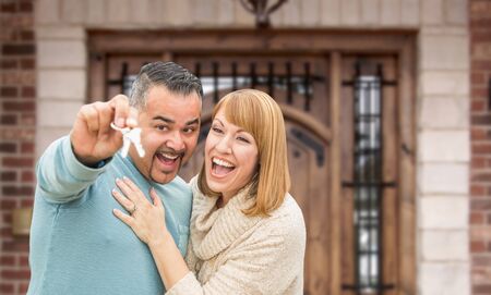 Mixed Race Couple In Front of Front Door of New House Holding Keys.の写真素材