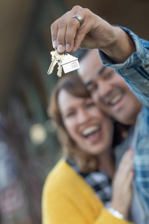 Mixed Race Couple Holding New House Keys.