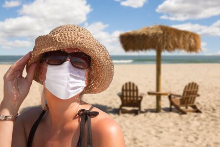 Vacationing Woman Wearing Face Mask on Sandy Beach..の写真素材