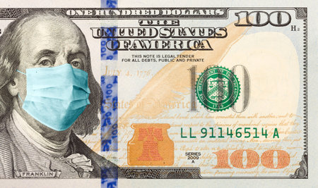 One Hundred Dollar Bill With Medical Face Mask on Benjamin Franklin.