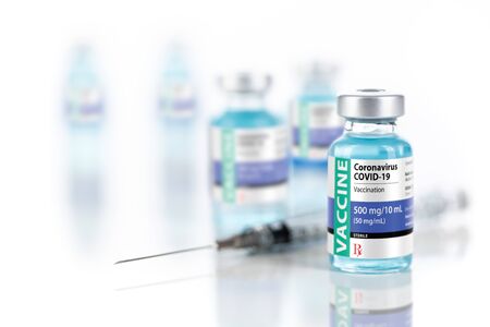Coronavirus COVID-19 Vaccine Vials and Syringe On Reflective Surface.の写真素材