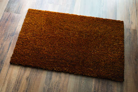Blank Dark Brown Welcome Mat On Wood Floor Background Ready For Your Own Text.の写真素材